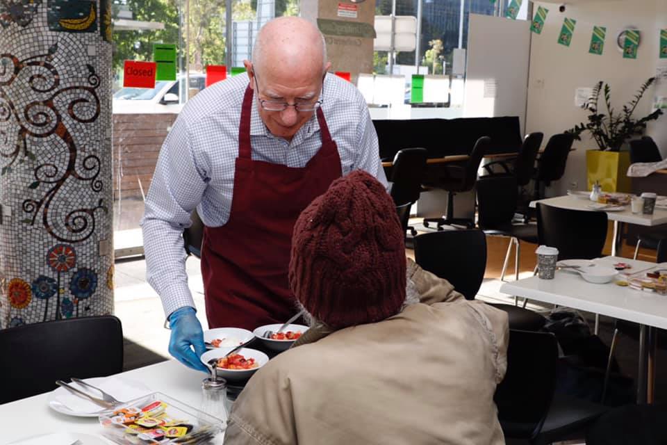 Governor-General serving food to a guest